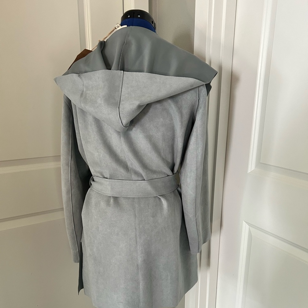 Listicle light blue suede jacket with hood, pockets and waist tie.